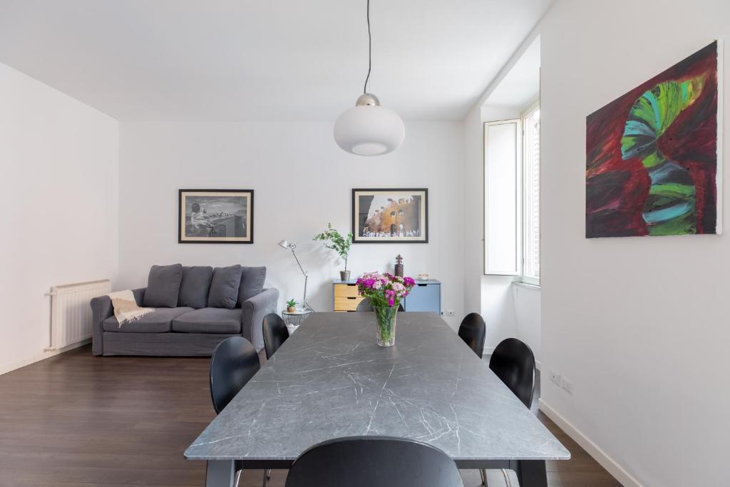 sala de estar con mesa y sofá en iFlat Monti Charming Apartment, en Roma