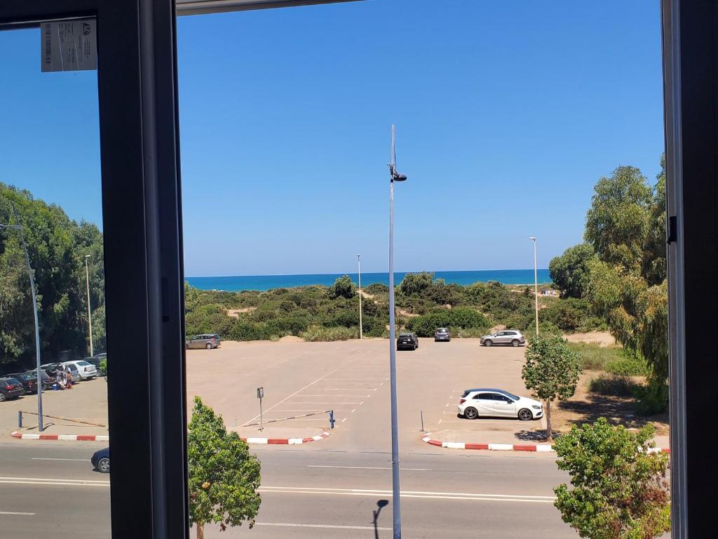 a view of a parking lot from a window at Superbe appartement avec vue sur mer in Saïdia