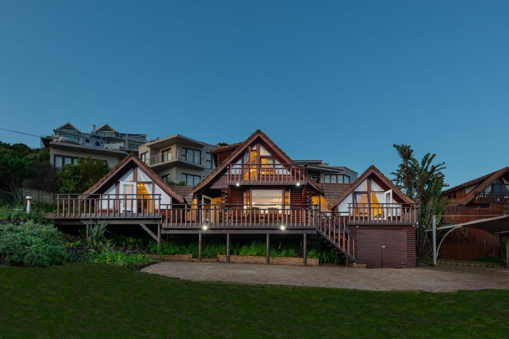 a large house with a large deck at Brenton on Sea Chalet in Brenton-on-Sea
