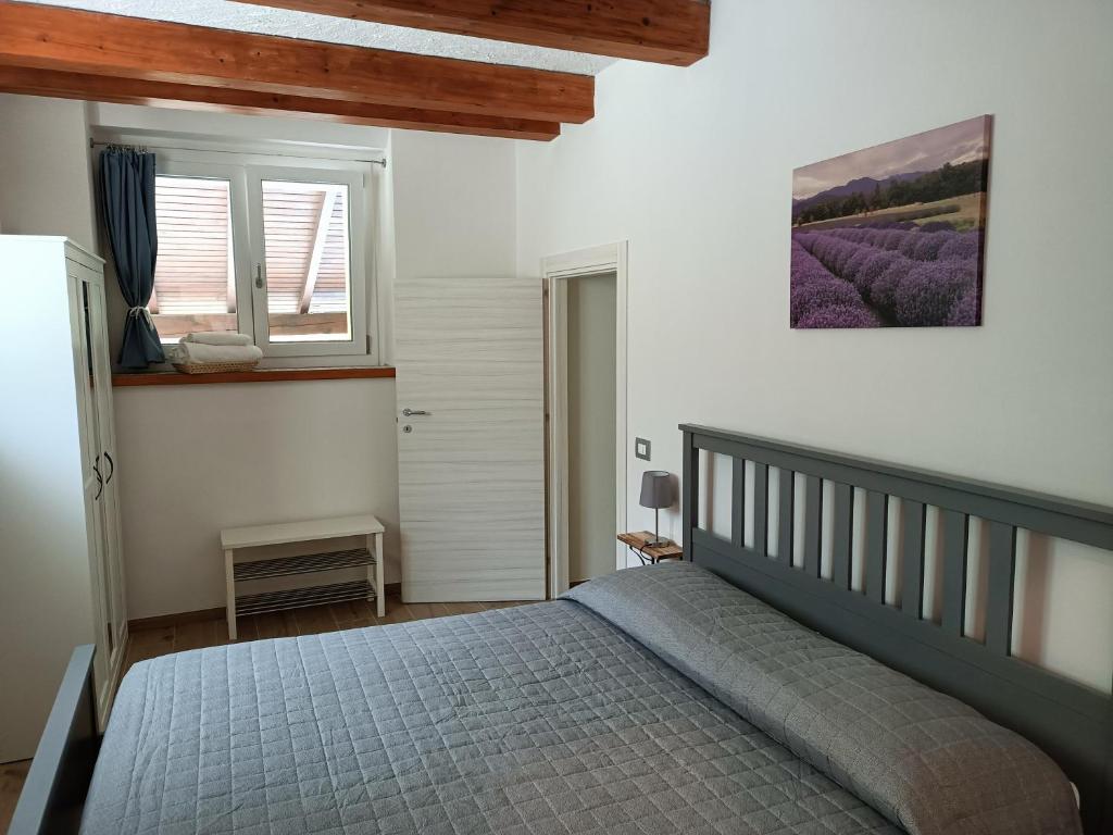 a bedroom with a bed and a window at B&B Il Ghiro in Riolunato