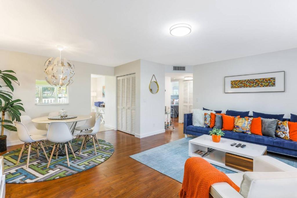 a living room with a blue couch and a table at The Shore Club at Park Shore in Naples