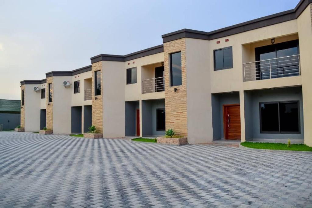 an empty parking lot in front of a building at Royal Suites Apartments in Lusaka