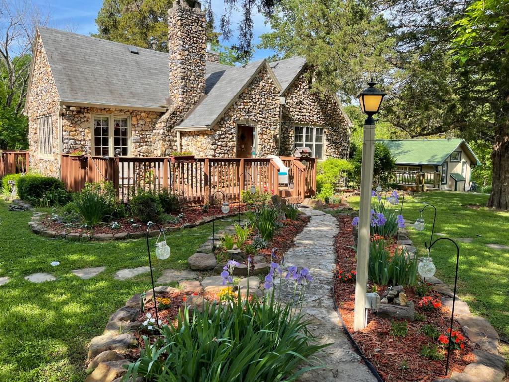 a garden in front of a stone house at Rock Cottage Gardens B&B in Eureka Springs