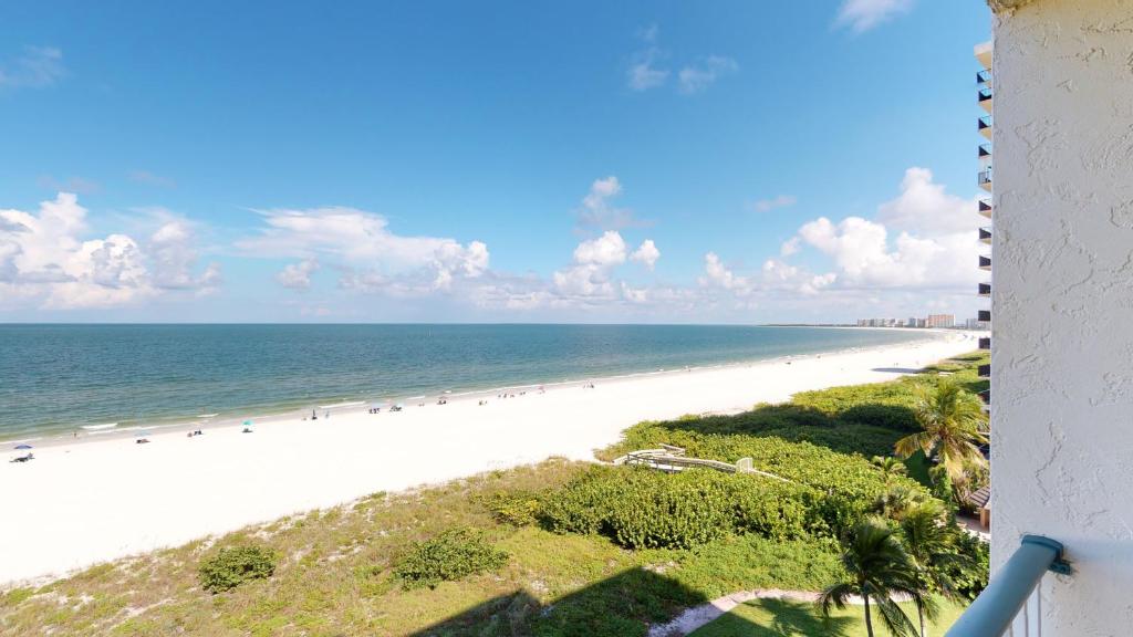 a view of the beach from the balcony of a condo at Beachfront at the Apollo Where the Famous Sunsets Never Get Old! in Marco Island