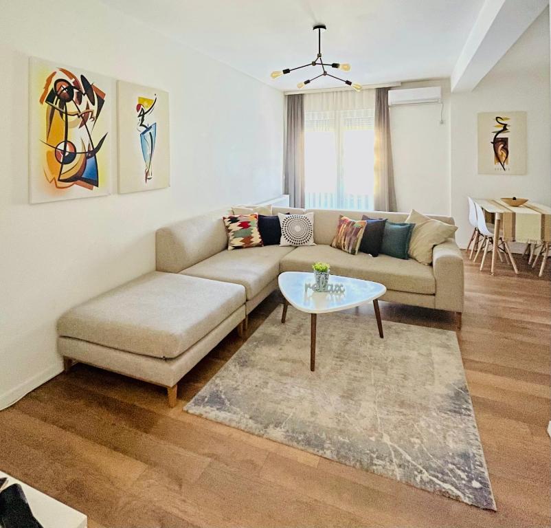 a living room with a couch and a table at Tower apartment in Prishtinë