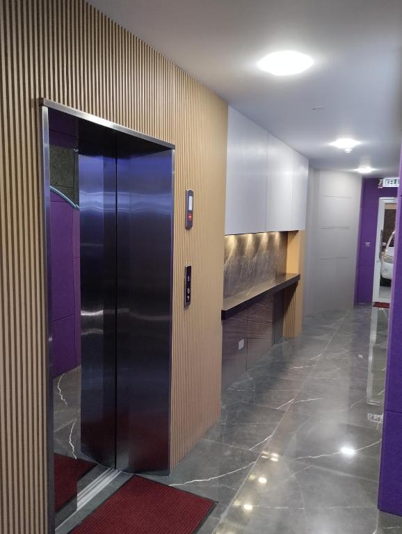 a elevator in a building with a black door at Qing Yun Rest House Koprijaya, Brunei Darussalam in Bandar Seri Begawan
