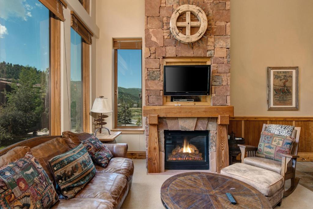 a living room with a fireplace and a tv at The Lodges at Deer Valley-A - #5323 in Park City