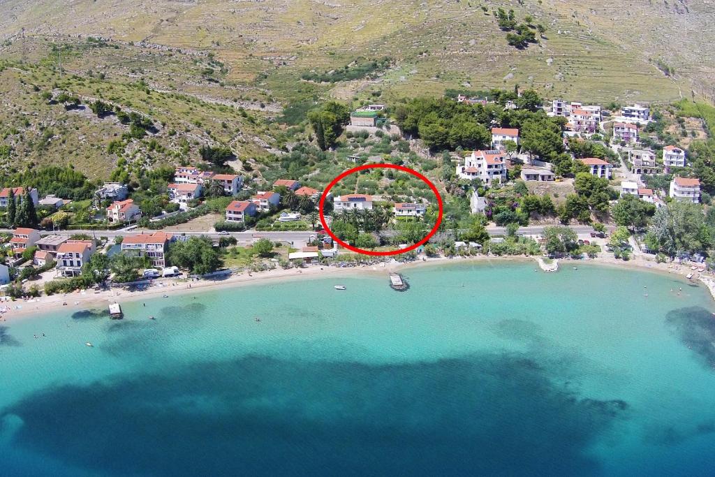 an aerial view of a beach with a red circle at Apartments by the sea Duce, Omis - 5987 in Duće