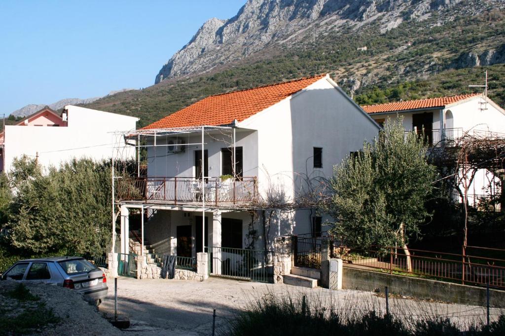 a house under construction with a mountain in the background at Apartments with parking space Podaca, Makarska - 6055 in Podaca