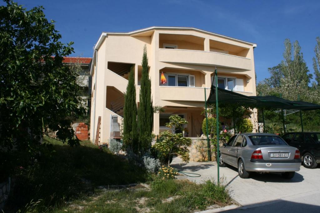 a house with a car parked in front of it at Apartments by the sea Rtina - Miocici, Zadar - 6210 in Ražanac
