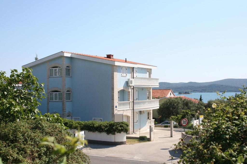 a blue building on the side of a street at Apartment Sveti Petar 6158c in Sveti Petar