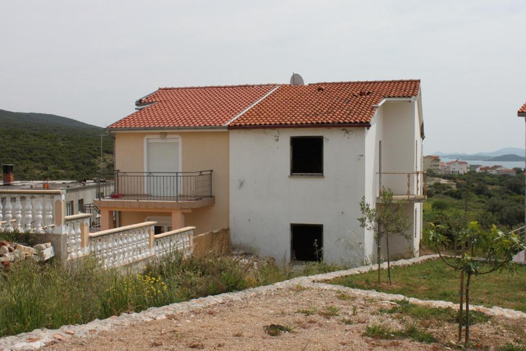 a white house with a red roof at Apartments with a parking space Sveti Petar, Biograd - 6169 in Sveti Petar