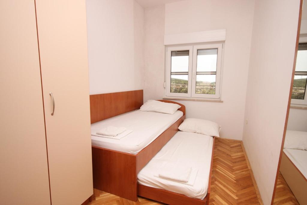 a small room with two beds and a window at Apartments with a parking space Sveti Petar, Biograd - 6169 in Sveti Petar