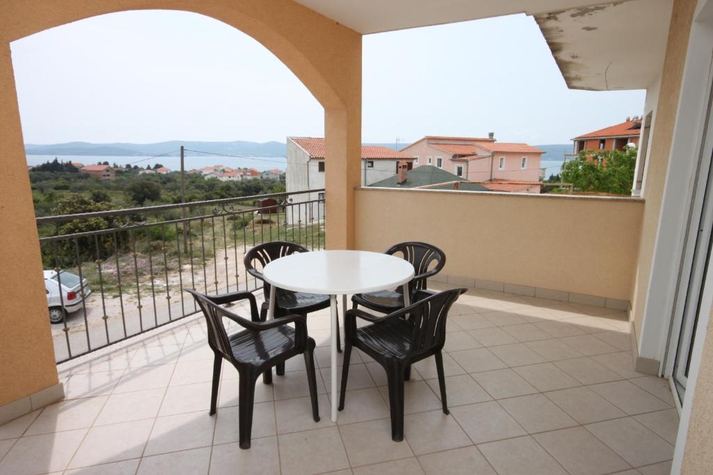 a balcony with a table and chairs and a view at Apartments with a parking space Sveti Petar, Biograd - 6169 in Sveti Petar