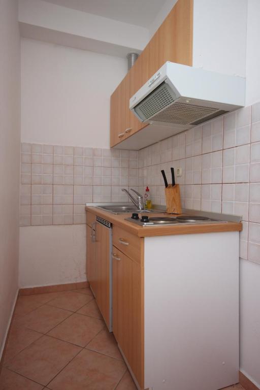 a small kitchen with a sink and a stove at Apartments with a parking space Sveti Petar, Biograd - 6169 in Sveti Petar