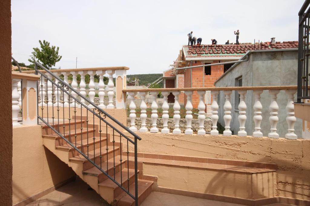 a balcony with a staircase with people on the roof at Apartments with a parking space Sveti Petar, Biograd - 6169 in Sveti Petar
