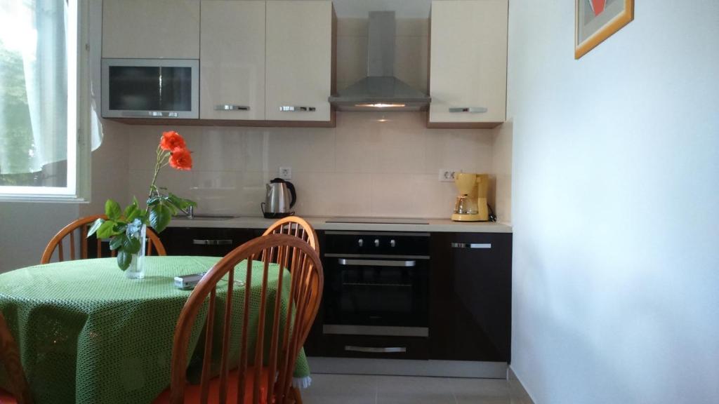 a kitchen with a table and a stove top oven at Apartments with a parking space Rabac, Labin - 7442 in Rabac