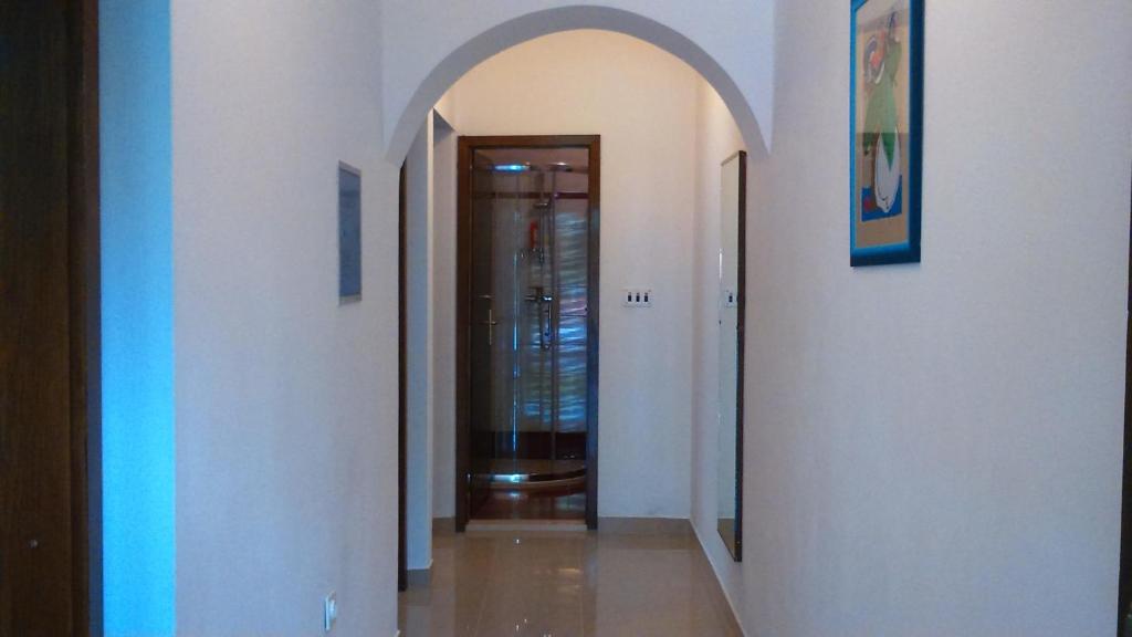 a hallway with an archway leading to a door at Apartments with a parking space Rabac, Labin - 7442 in Rabac