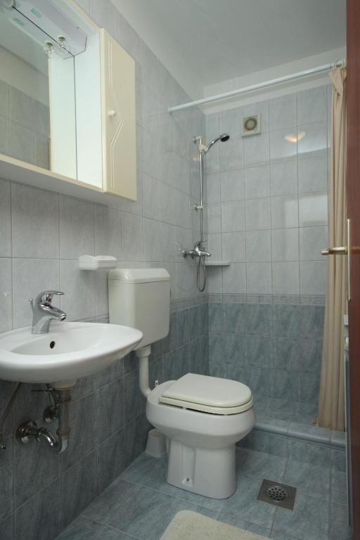 a bathroom with a toilet and a sink and a shower at Apartments with a parking space Rabac, Labin - 7442 in Rabac