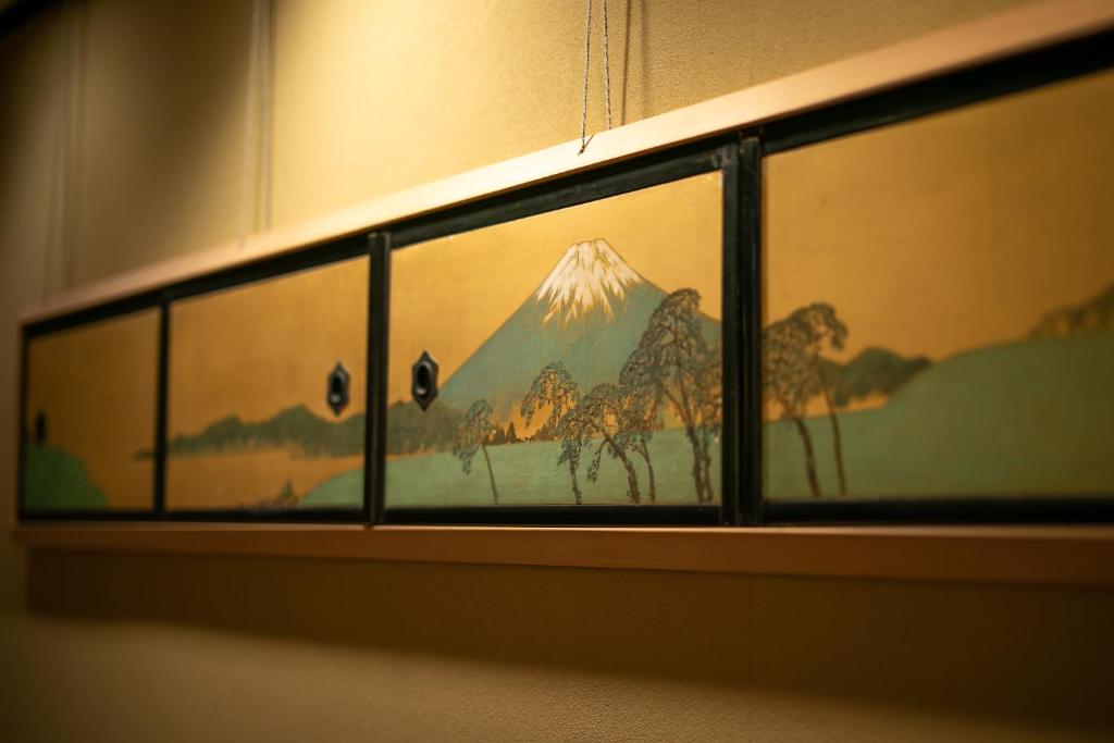 a painting of a mountain on a wall at Hotel Hagoromo in Shizuoka