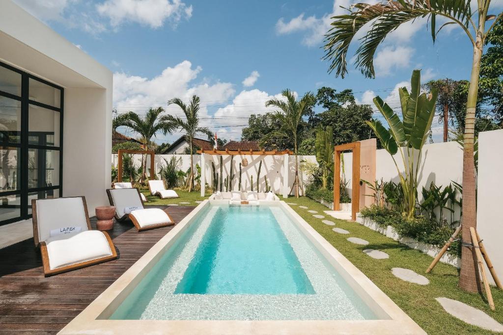 a swimming pool in the backyard of a house at Villa Lamer Canggu in Canggu
