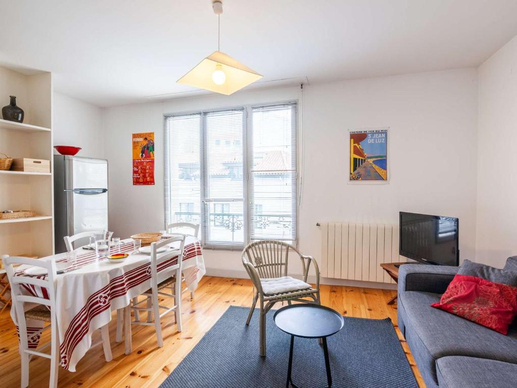 un salon avec une table et un canapé dans l'établissement Charmant appartement au centre-ville de Saint-Jean-de-Luz, plage et commerces à proximité - FR-1-4-651, à Saint-Jean-de-Luz