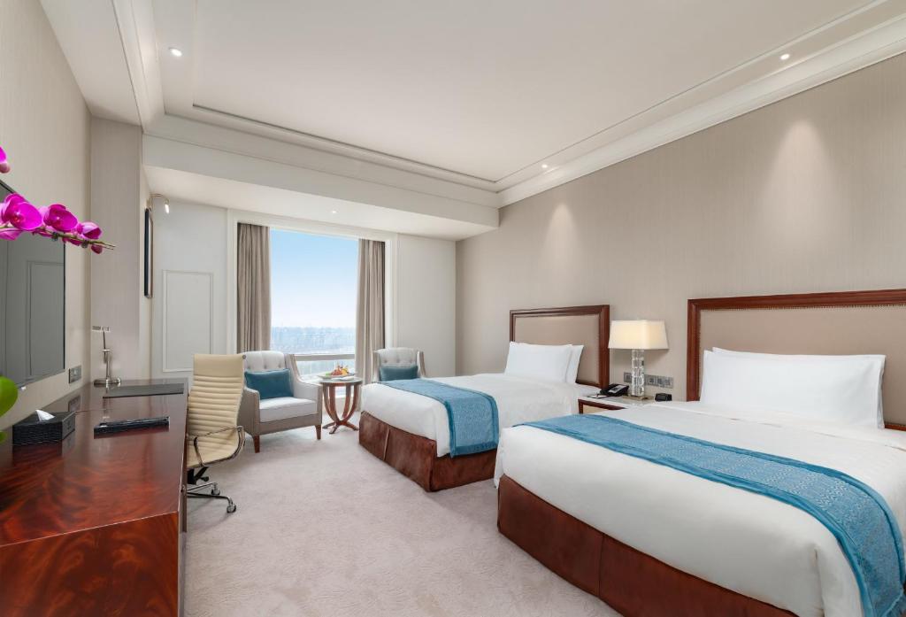 Postel nebo postele na pokoji v ubytování Jeurong Hotel Shanghai