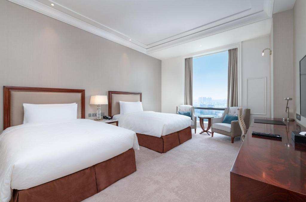Postel nebo postele na pokoji v ubytování Jeurong Hotel Shanghai