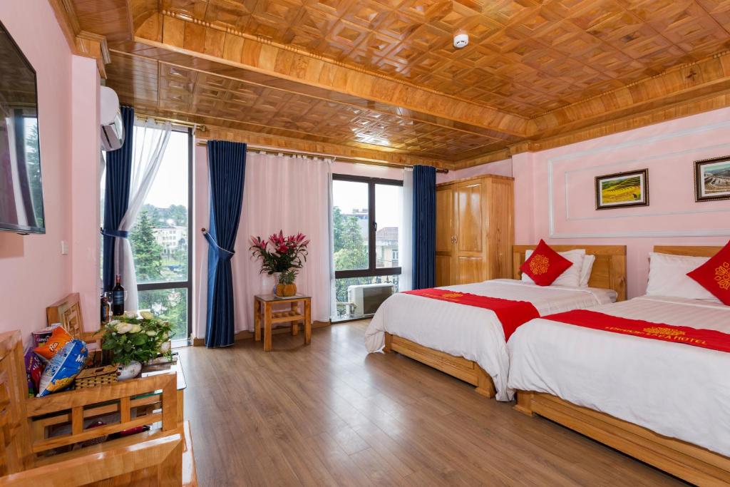Postel nebo postele na pokoji v ubytování London Sa Pa Hotel
