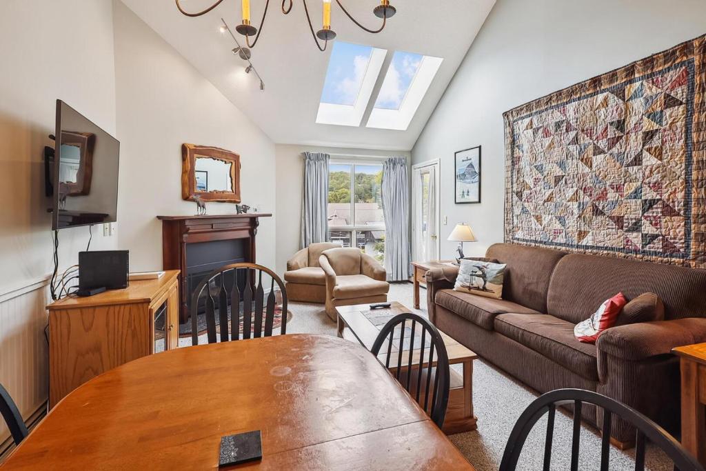a living room with a couch and a table at Pico F305 in Killington