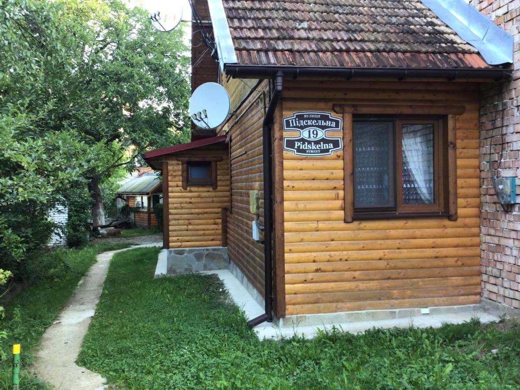 a cabin with a sign on the side of it at Квартира in Yaremche