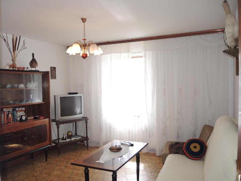 a living room with a couch and a tv at Apartment Rita RM in Portorož