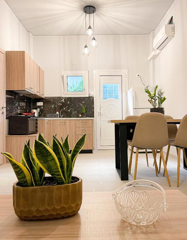 a kitchen and dining room with a table and chairs at Central neighborhood house in Stalida