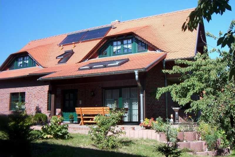a brick house with a bench in front of it at Kraeuter_Landhaus in Bad Schmiedeberg