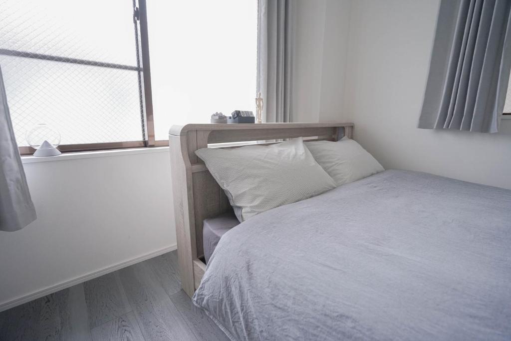 Postel nebo postele na pokoji v ubytování ZAITO Tokyo Skytree-Yokokawa II Studio 天空树旁舒适型民宿-宅东横II号店
