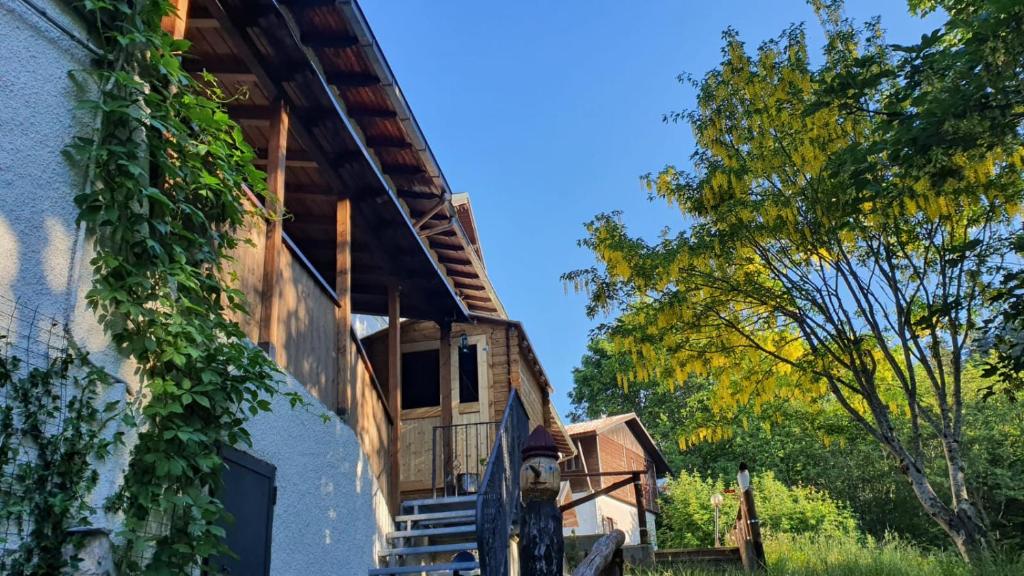 a house with vines growing on the side of it at B&B Chalet in Abetone