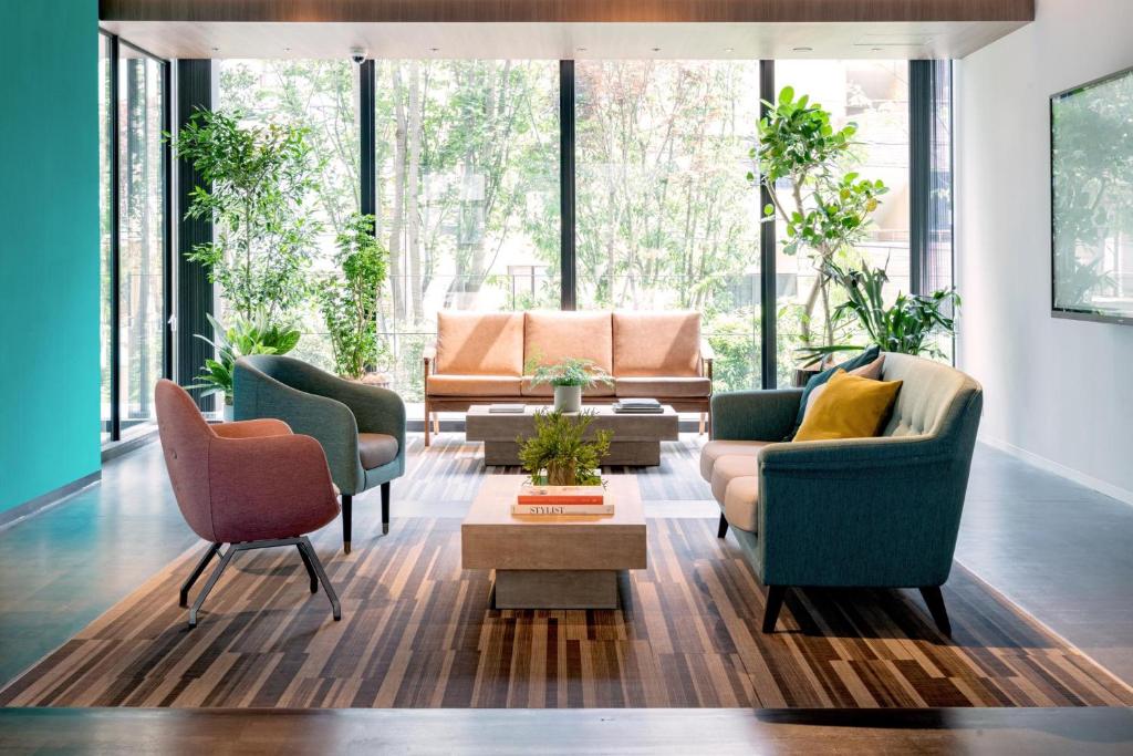 a living room with two chairs and a couch at Prince Smart Inn Ebisu in Tokyo