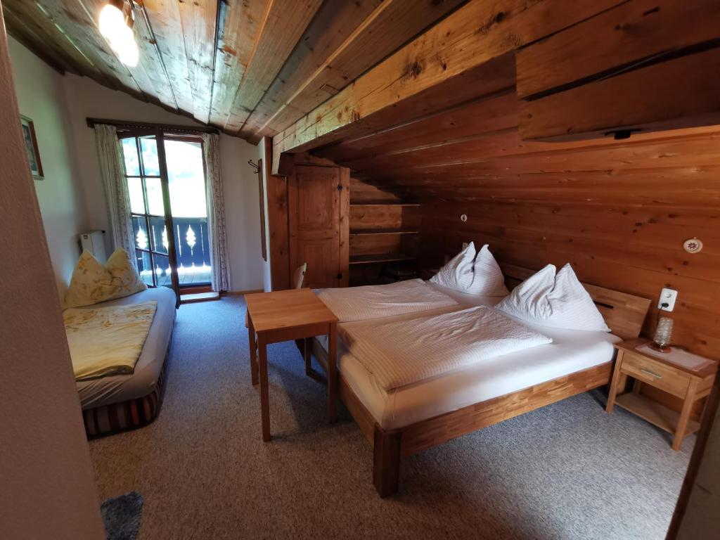 a room with two beds in a log cabin at Entfeldhof - Familie Schernthaner in Fusch an der Glocknerstraße