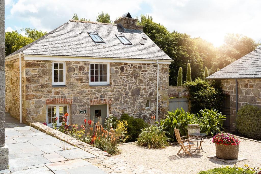 a stone house with a garden in front of it at Moon Cottage in Newquay