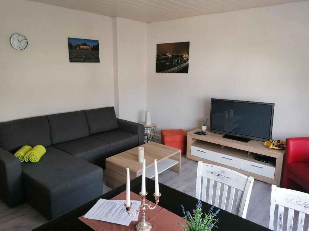 a living room with a couch and a table at Ferienwohnung Körner in Saarbrücken