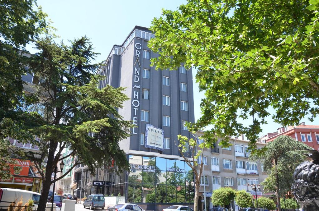 a tall building with a hotel sign on it at Grand Park Hotel Corlu in Çorlu