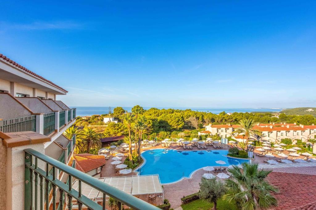 a view of the pool from the balcony of a resort at Valentin Son Bou in Son Bou