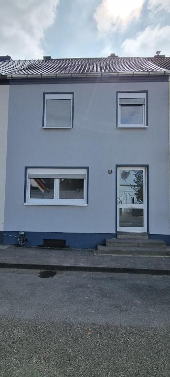 a white house with two windows on the side of it at Ferienhaus Thalia 3 in Übach-Palenberg