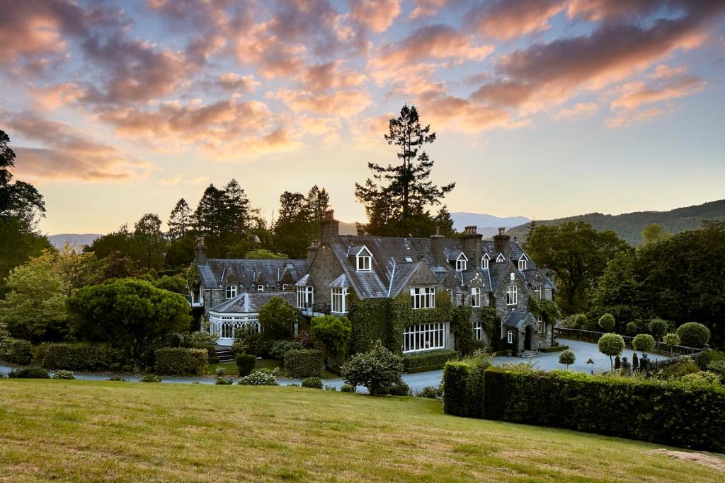 an estate in the hills with a large house at Penmaenuchaf Hotel in Dolgellau