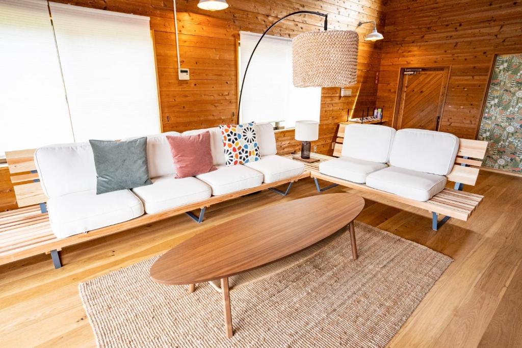 a living room with a white couch and a table at Cottage Coliberty - Vacation STAY 60563v in Anan