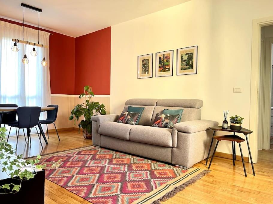 a living room with a couch and a table at Appartamento moderno in Tenuta Melloni in Anzola dell'Emilia