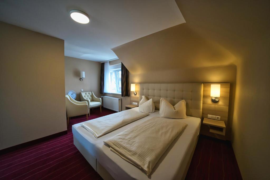 Postel nebo postele na pokoji v ubytování Hotel Tenner