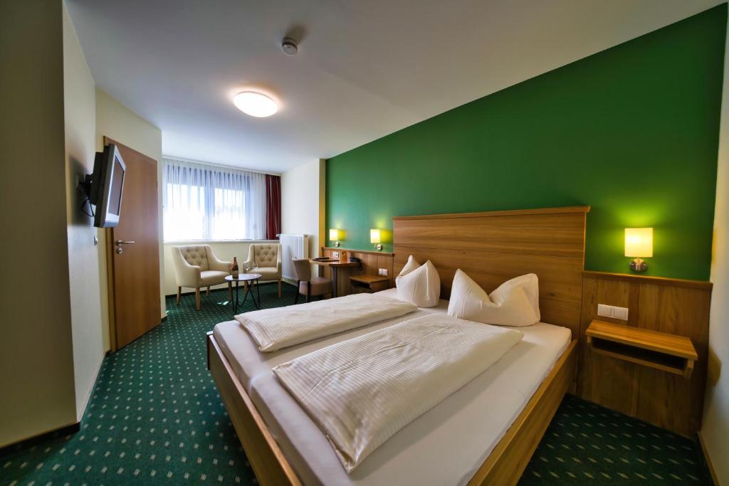 Postel nebo postele na pokoji v ubytování Hotel Tenner