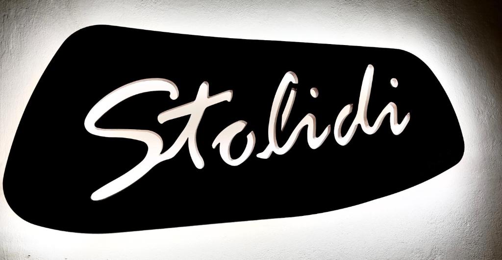 a black and white sign with the word sakura at Stolidi in Adamas