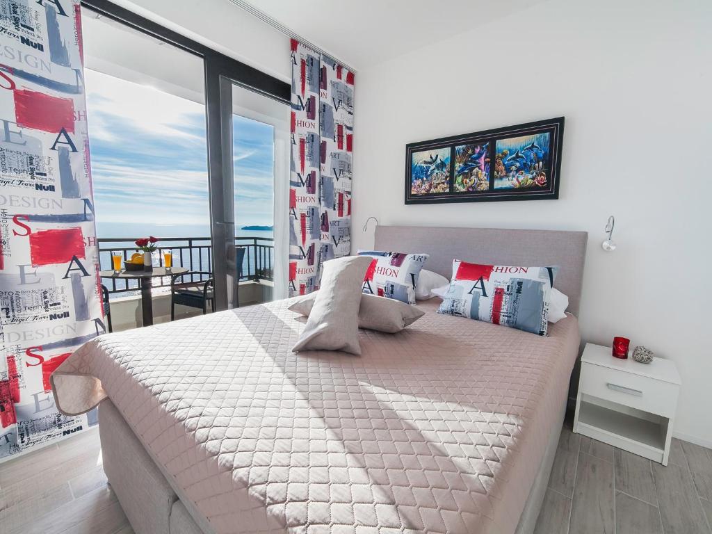 a bedroom with a bed with a view of the ocean at Villa Mona 2 in Budva